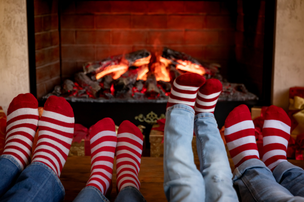 What working parents want employers to know at the holidays: a family with matching socks by the fire